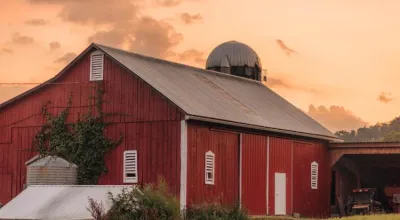A red barn against a sunset